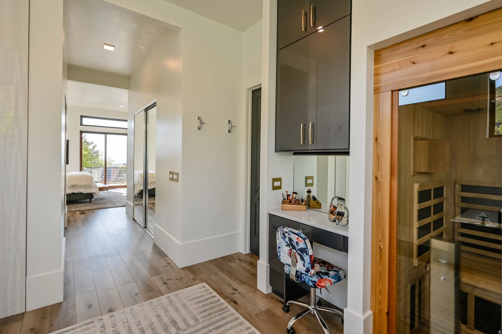 Hallway featuring wood-finish flooring and integrated cabinetry