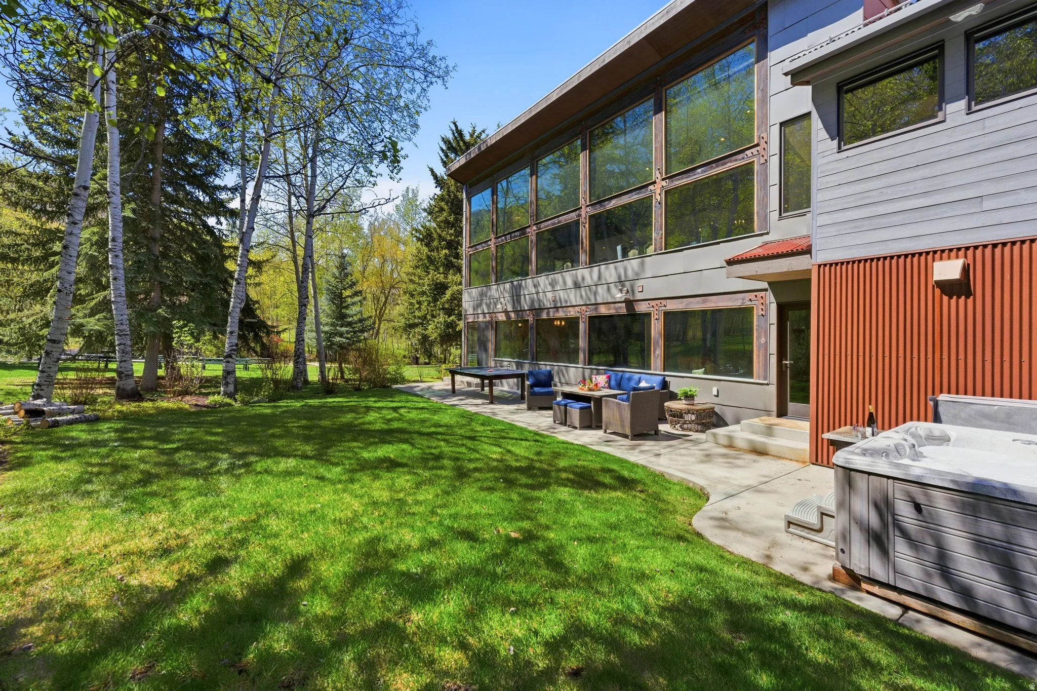 Modern exterior with expansive windows and a large patio