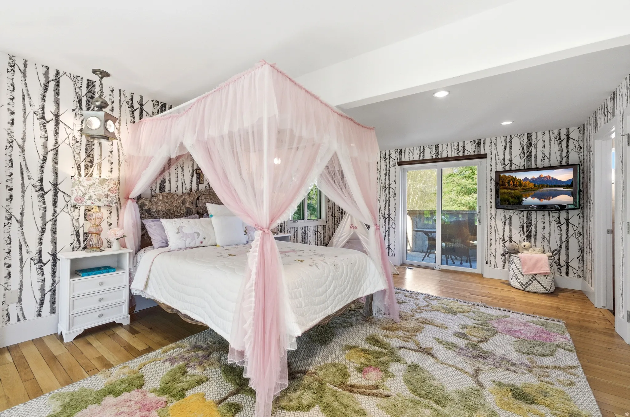 Bedroom featuring wood-finish flooring, recessed lighting, and sliding glass doors opening to an exterior space