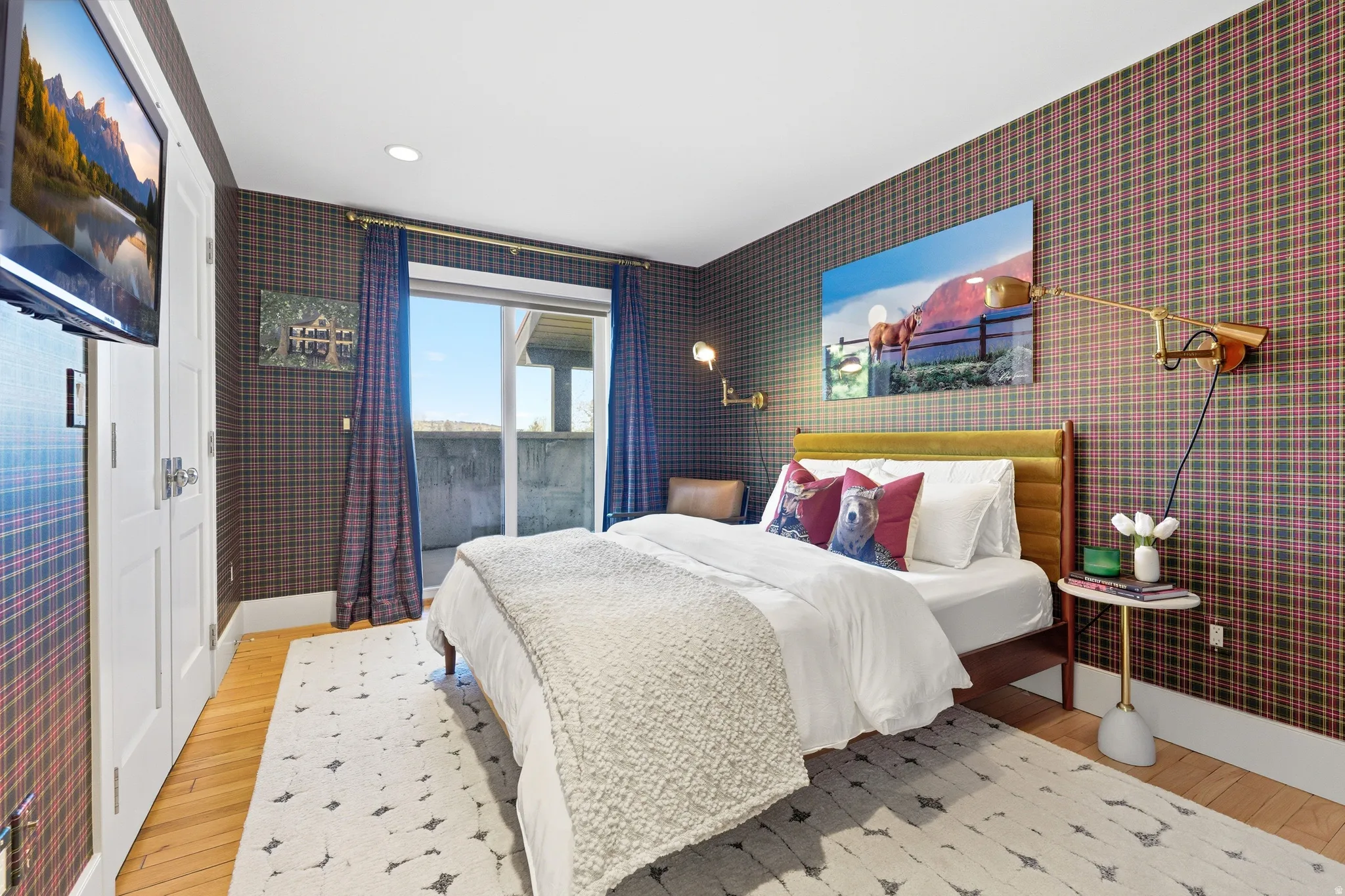 Bedroom featuring plaid pattern wall covering, wood-finish flooring, a sliding glass door providing exterior access, and recessed lighting