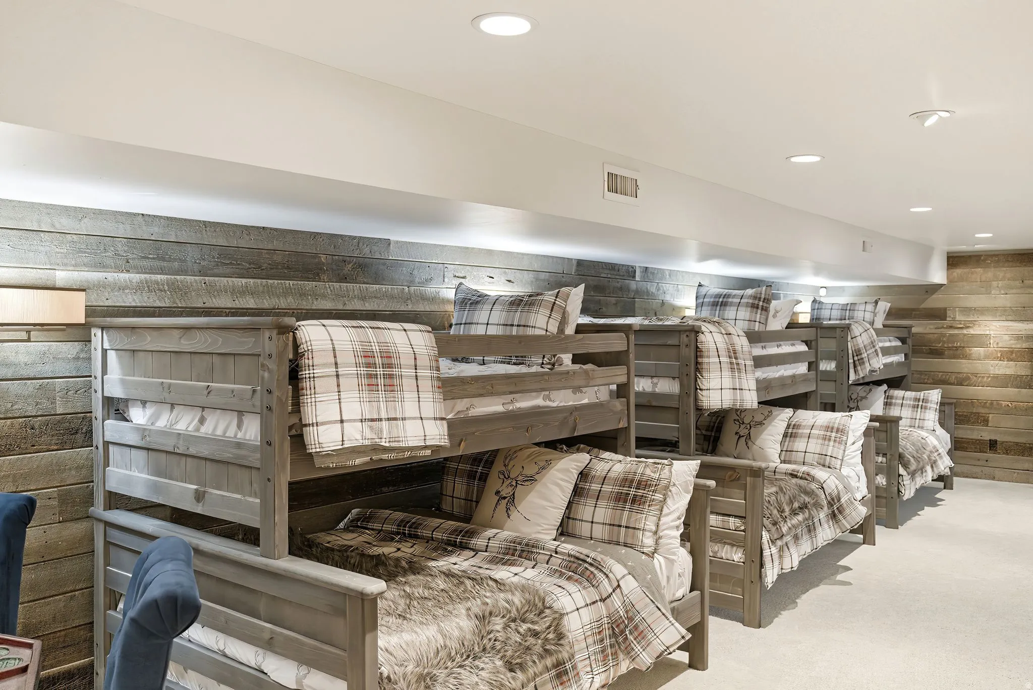 Room featuring multiple bunk beds with wood frames