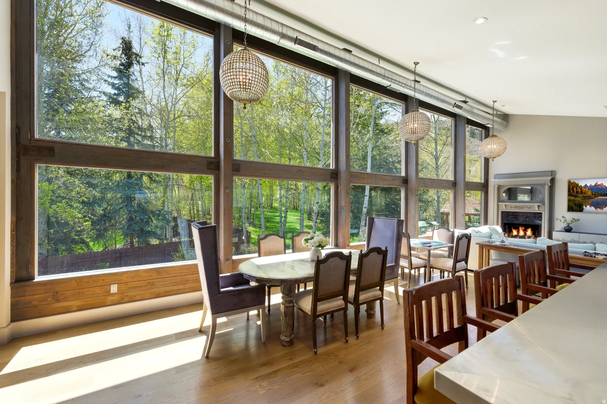 Expansive window wall with dark wood framing, providing abundant natural illumination