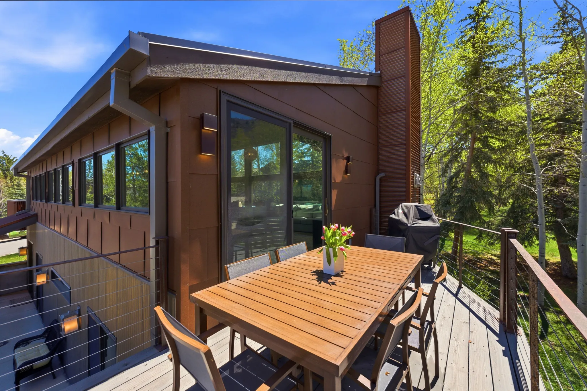 Spacious outdoor deck featuring cable railings and wood-finish flooring