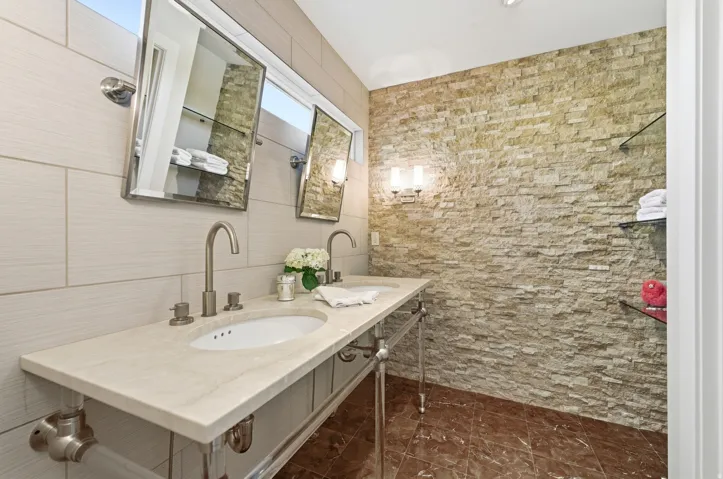 Dual vanity featuring a light-toned countertop with integrated sinks and brushed nickel fixtures