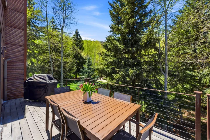 Outdoor deck with wood-finish flooring and a cable railing system