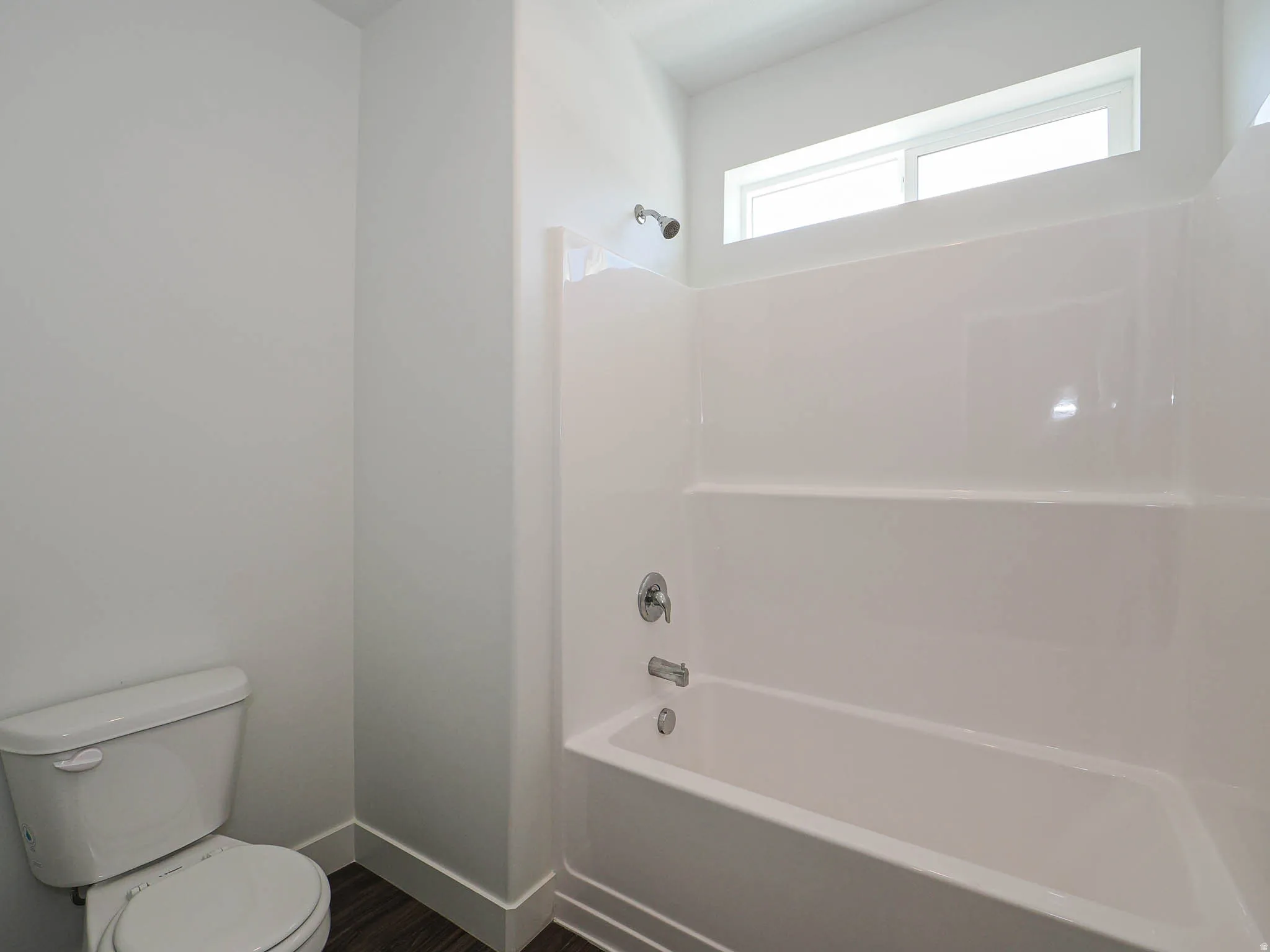 White fiberglass tub/shower combination with chrome fixtures