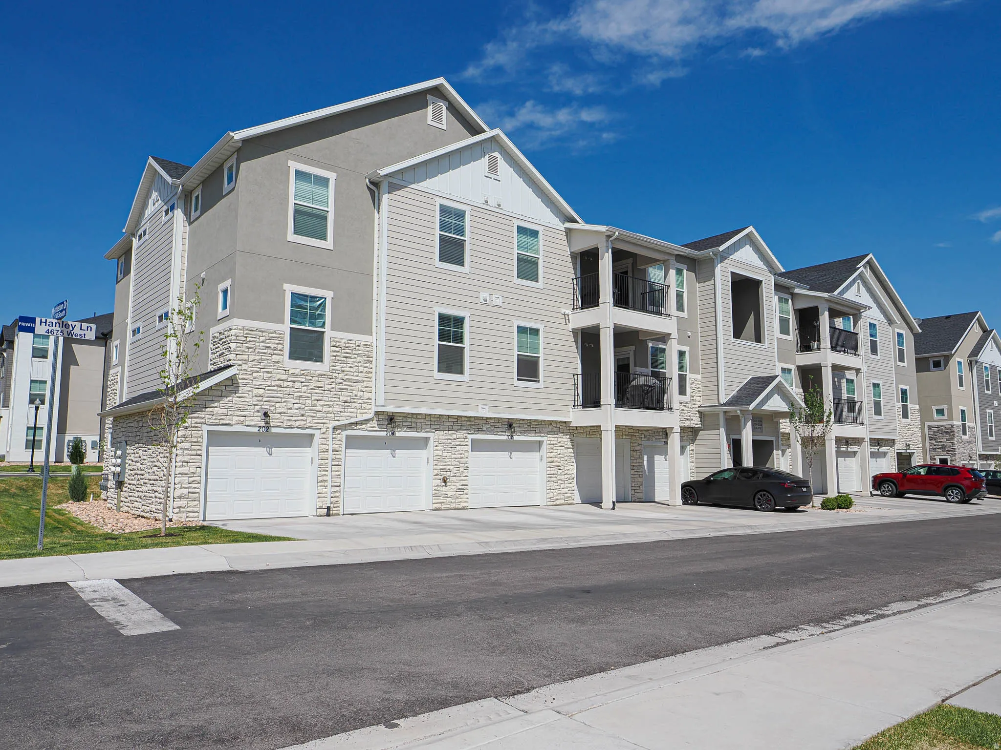 Multi-story residential building featuring textured stucco and horizontal siding