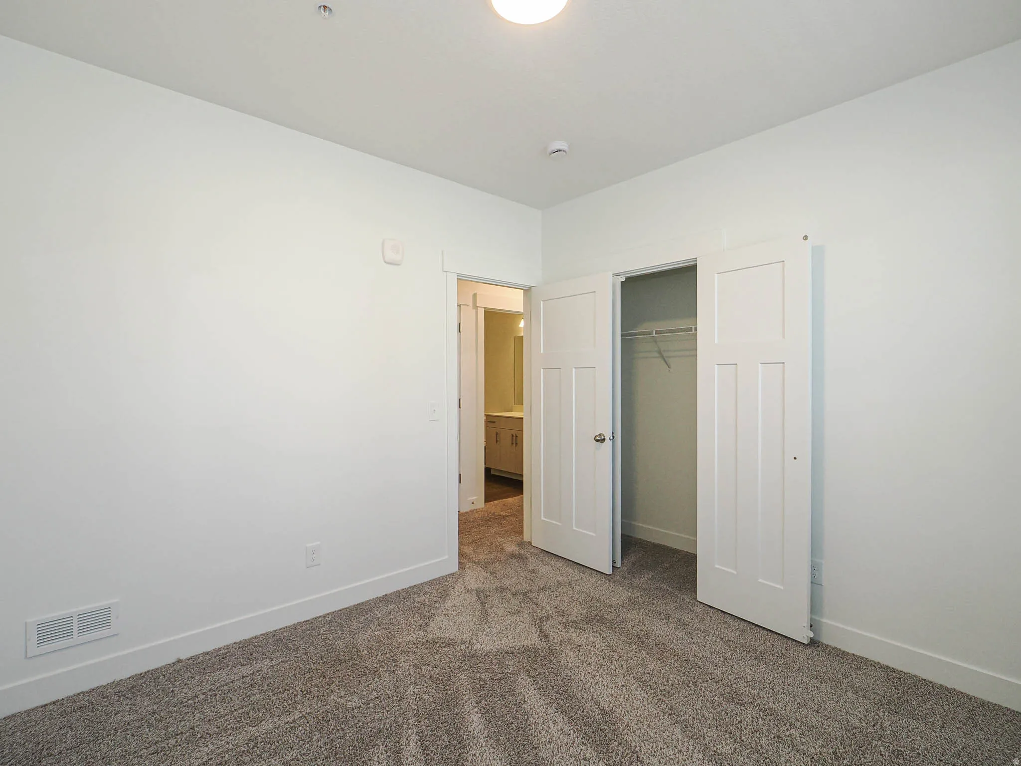 Neutral-toned carpeting complementing white walls and trim