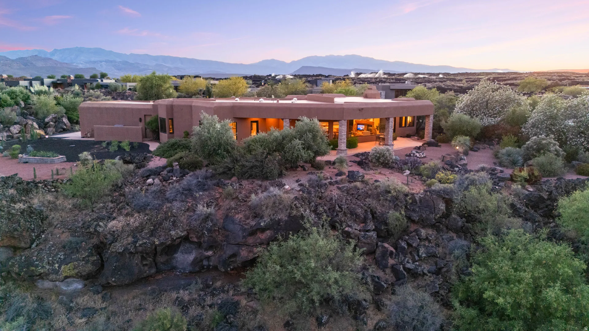 Southwestern-style architecture featuring a warm earth-toned stucco exterior and a flat roofline