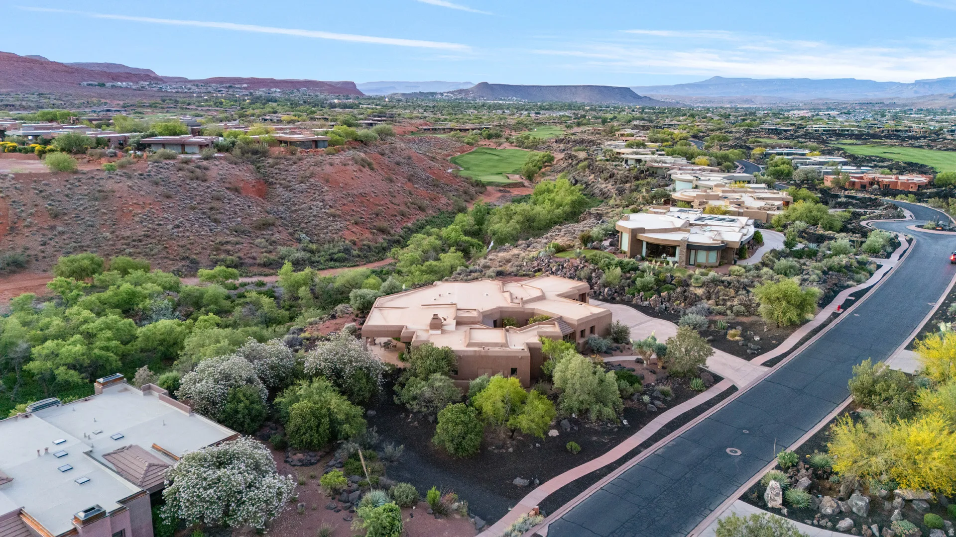 Aerial perspective featuring a southwestern-style residence with a flat roofline