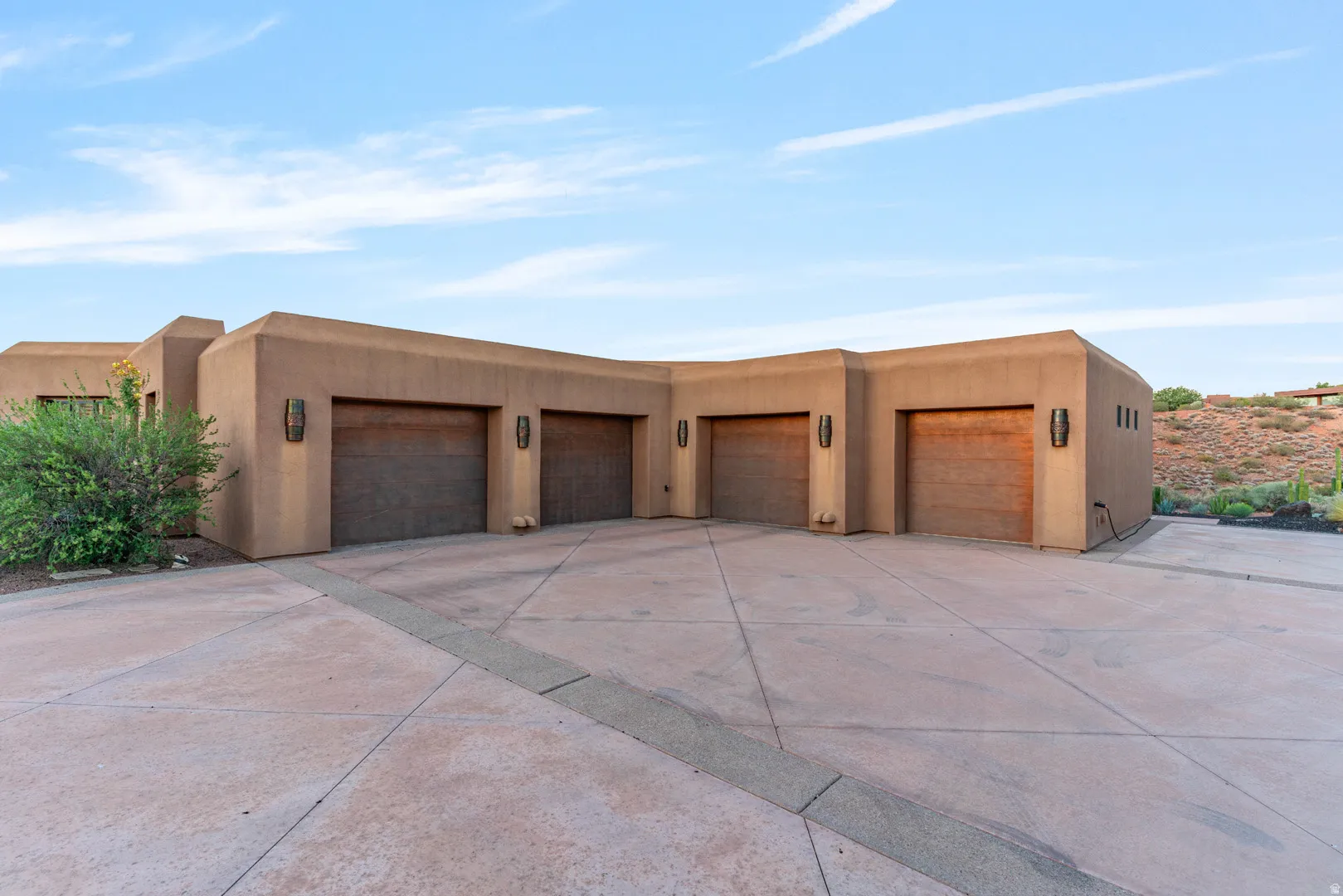 Multi-vehicle garage with four individual wood-panel garage doors