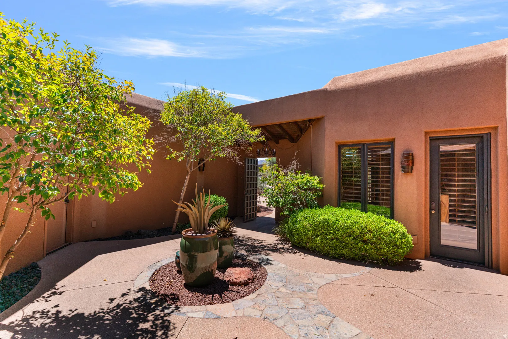 Southwestern-style exterior featuring a textured stucco finish and a flat roofline