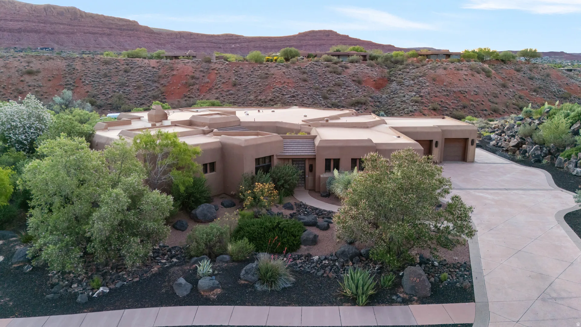Southwestern-style residence featuring a stucco exterior and flat roofline