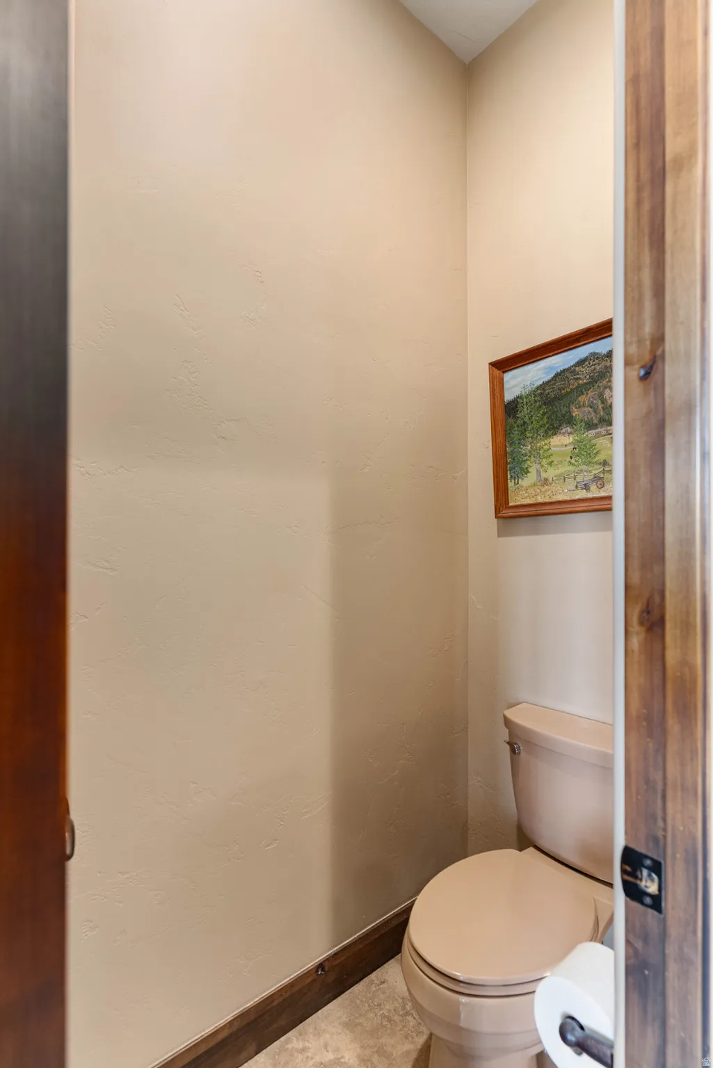 Primary bathroom with neutral-toned walls complement the full-sized toilet