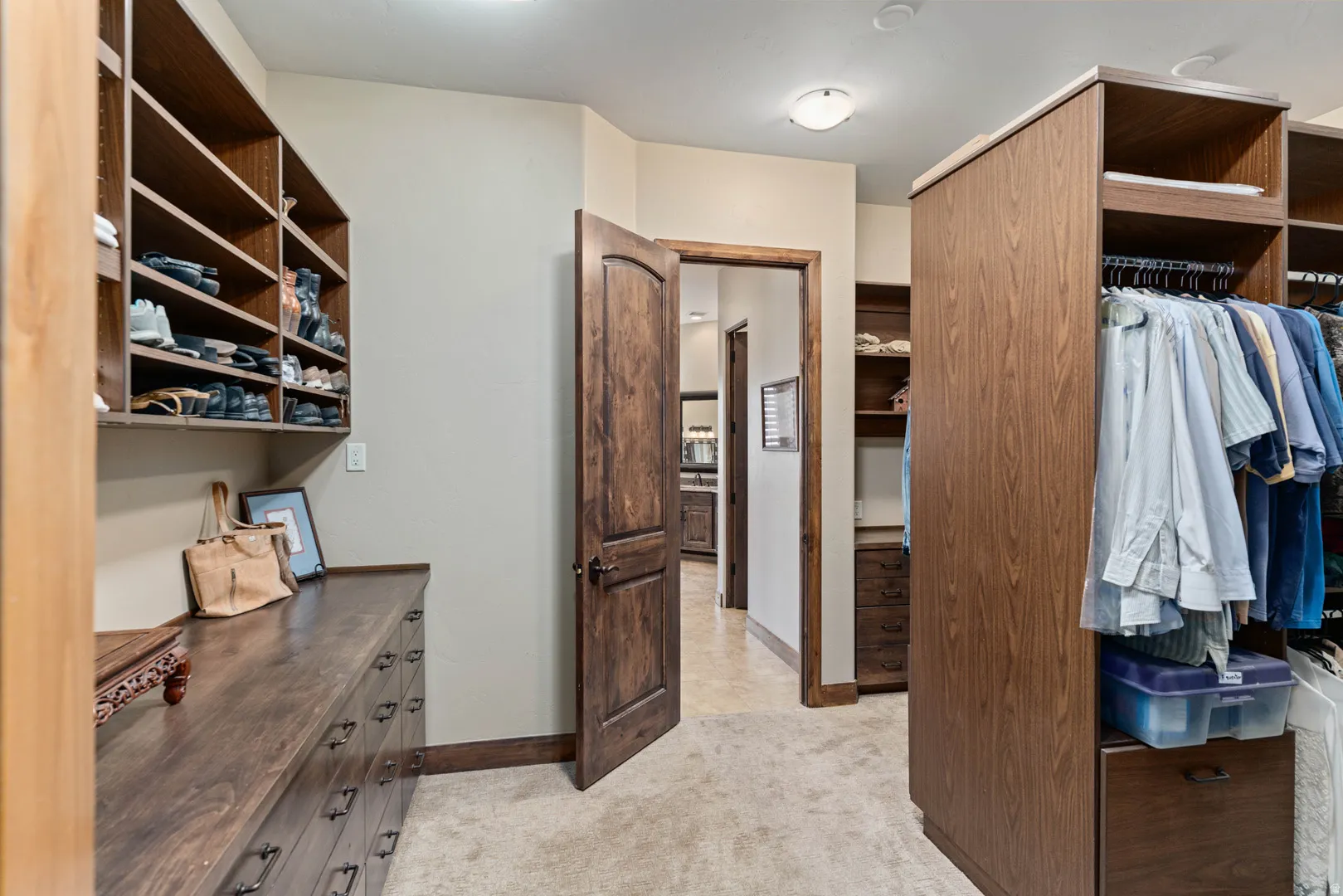 Custom wood-finish closet system featuring integrated shelving and hanging rods