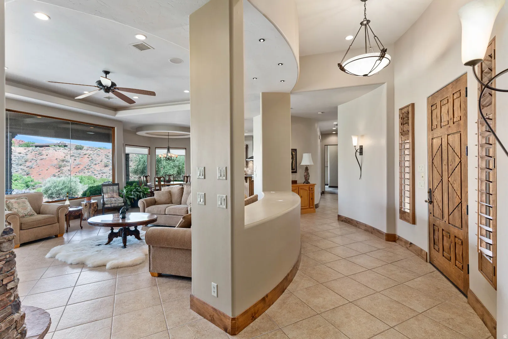 Open-concept interior featuring large format tile flooring and a curved architectural partition