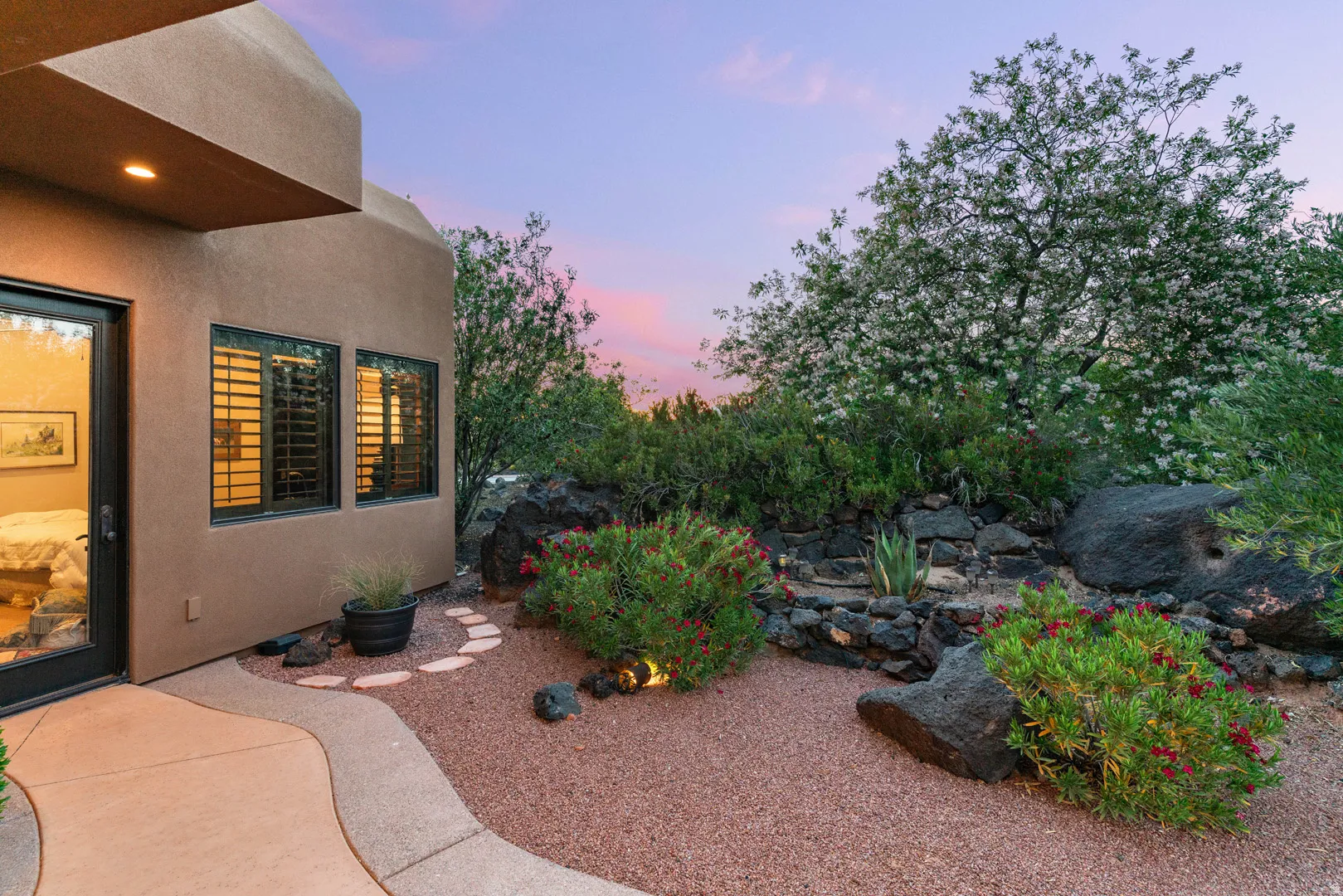 Southwestern-style exterior with a stucco finish and a modern glass entry door