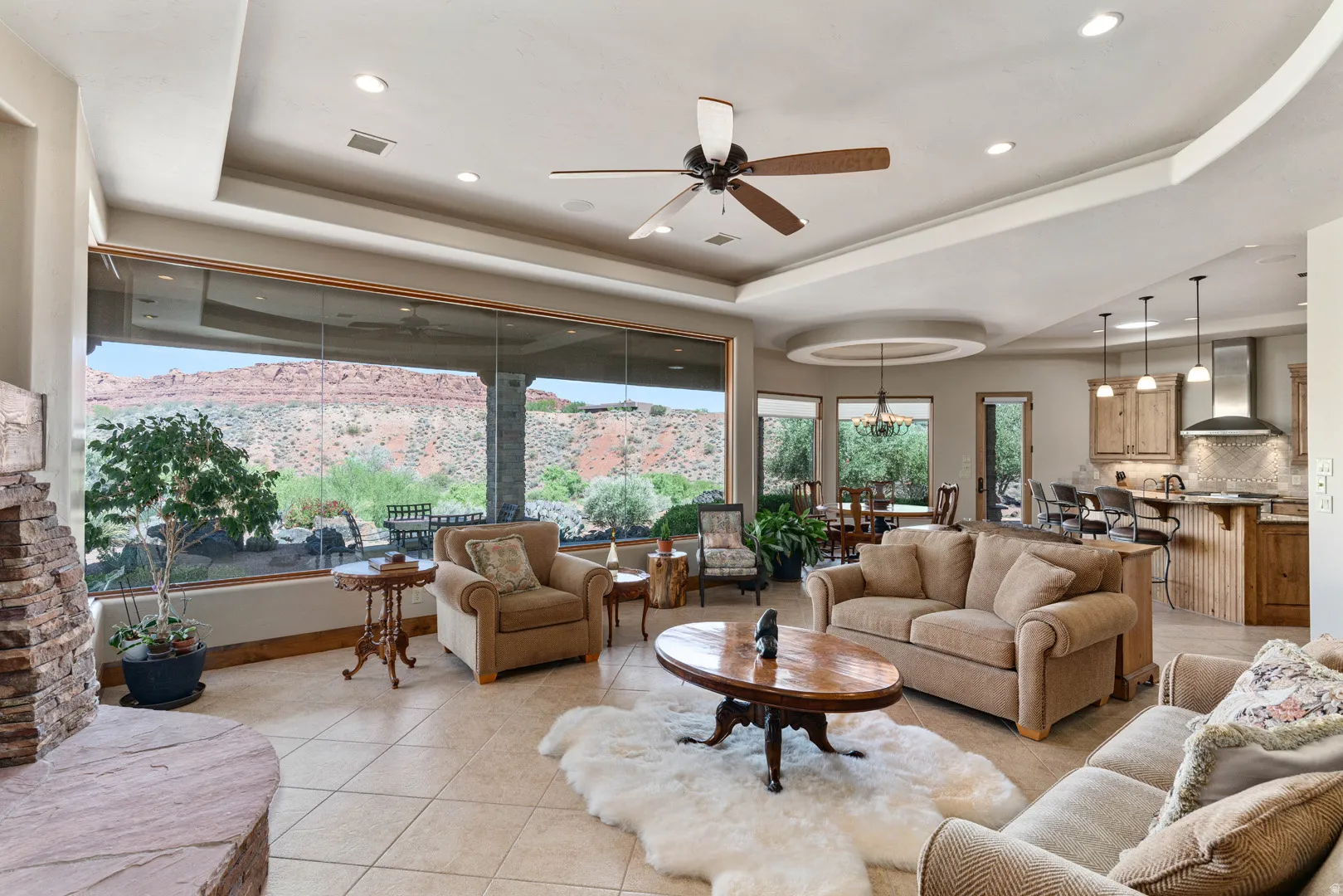Great room featuring expansive windows, recessed lighting, tile flooring, a ceiling fan, and a stone fireplace
