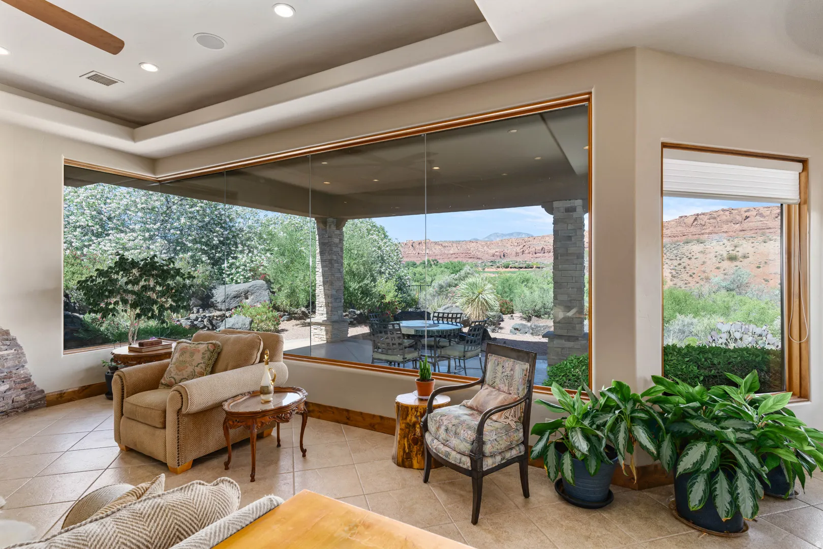Expansive windows showcasing desert landscaping and distant mountain scenery