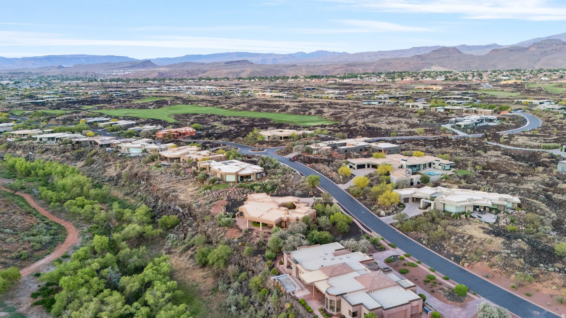 Residential community featuring extensive paved roadways, abundant native landscaping, and distinctive architecture