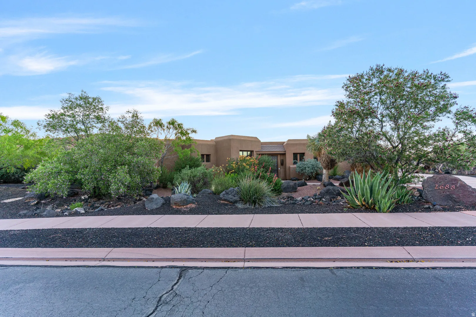 Southwestern-style residence featuring a stucco exterior with a flat roofline