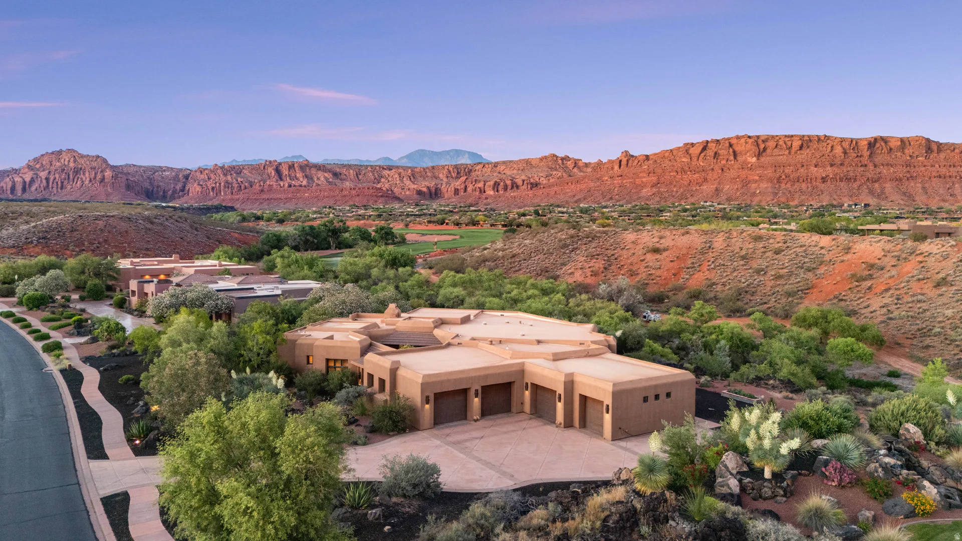 Southwestern-style residence featuring a stucco exterior and multi-car garage