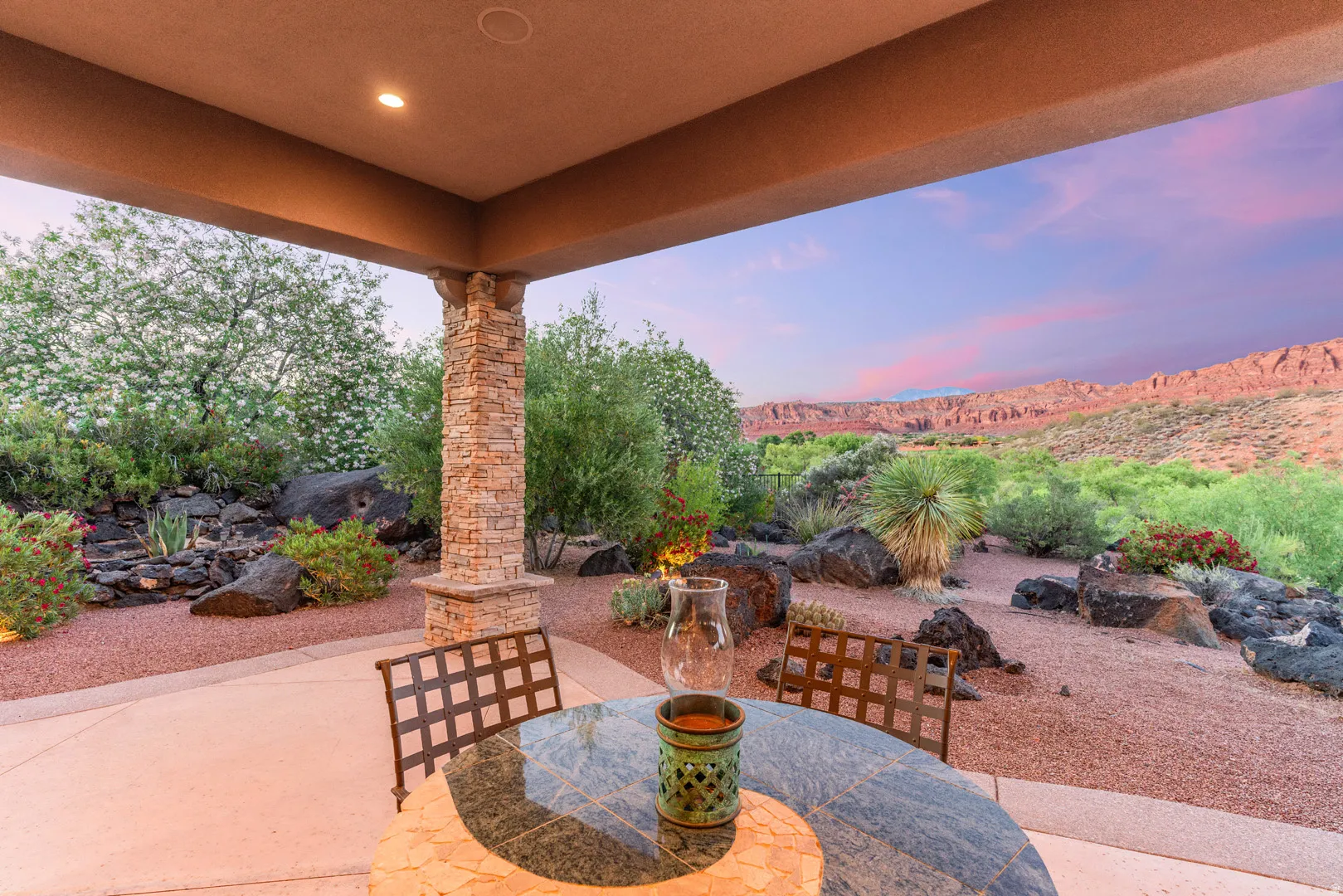 Covered patio featuring a stacked stone pillar, recessed lighting, and a concrete floor