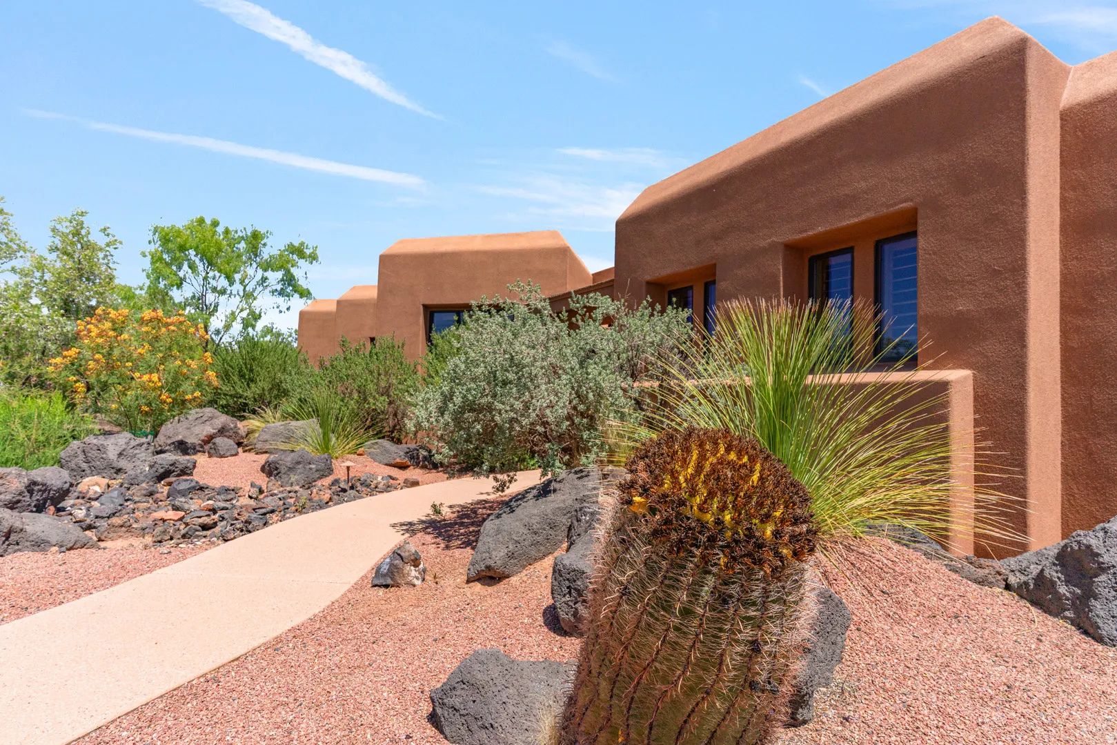 Southwestern-style exterior featuring a stucco finish and dark-framed windows