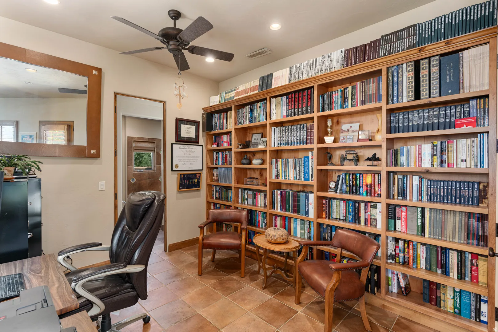 Room featuring extensive built-in wooden shelving
