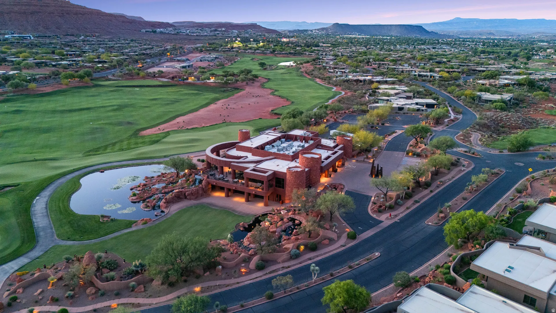 Architectural structure of clubhouse with multiple levels and rounded towers, featuring an expansive surrounding landscape