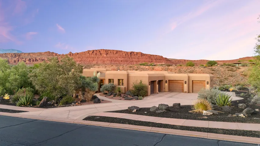 Southwest-style residence featuring a stucco exterior and multi-car garage