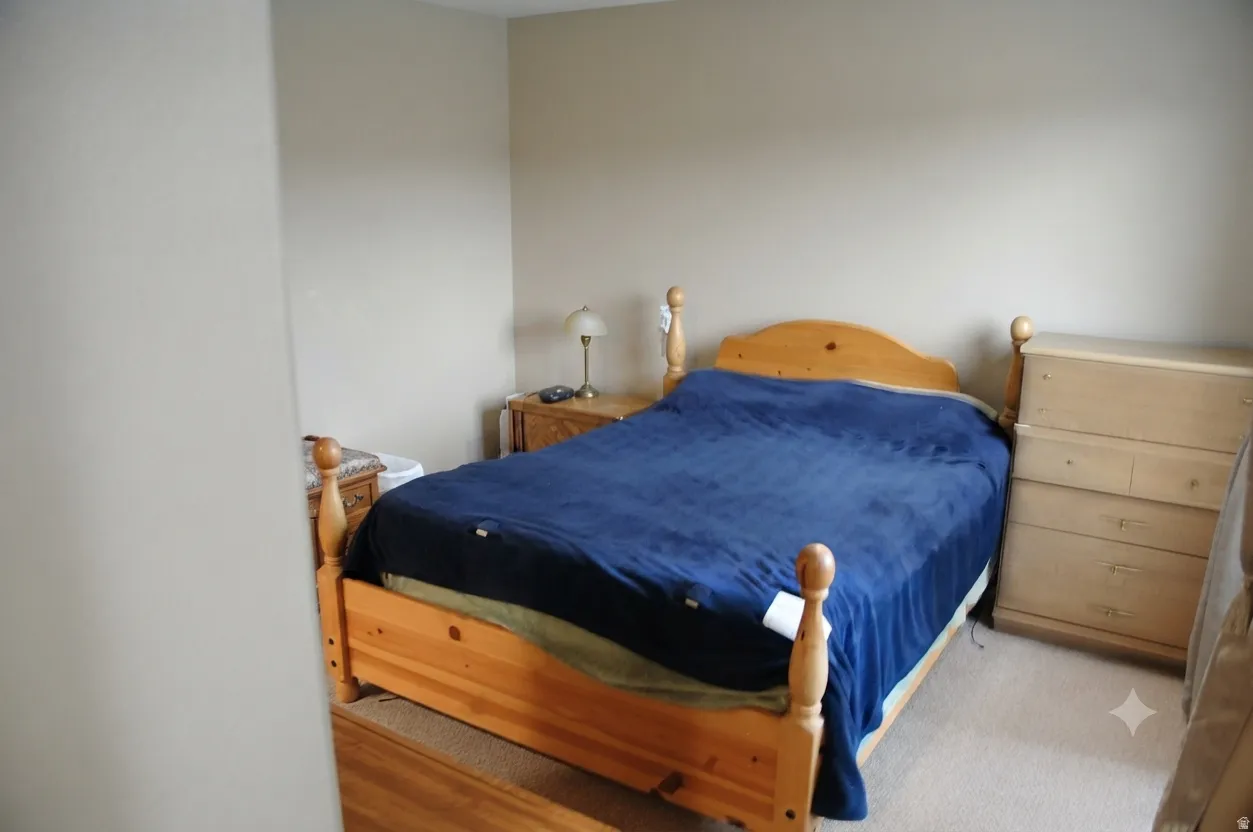 Spacious room with neutral wall tones and light-colored carpeting