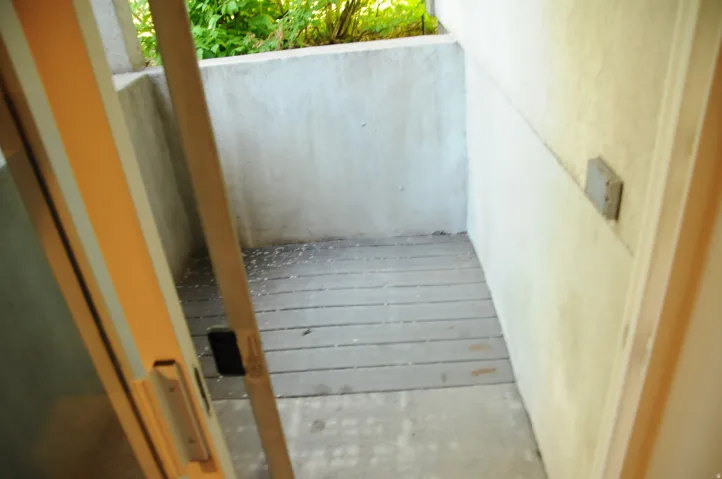 Private outdoor patio featuring plank flooring and stucco walls