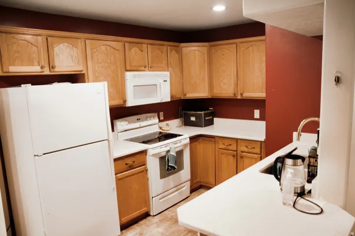 Kitchen featuring light wood cabinetry, white countertops, built-in microwave, and recessed lighting