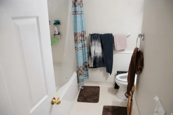 White tub and shower combination with a standard toilet