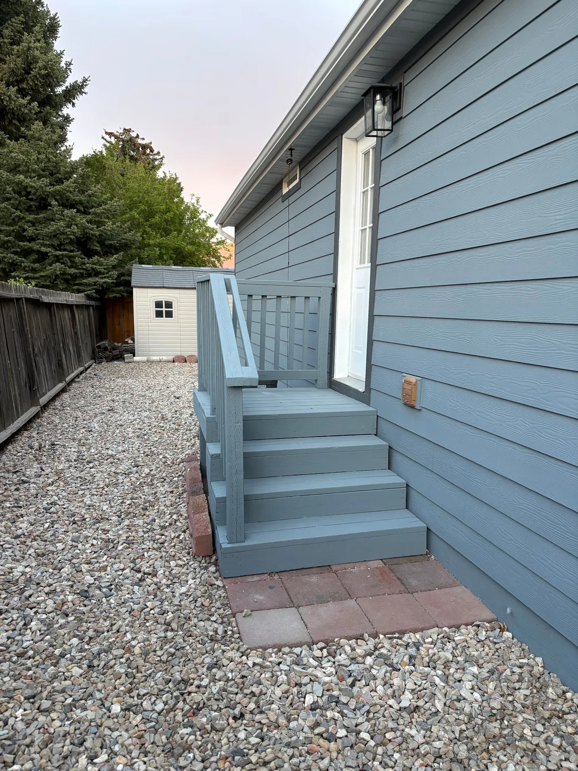 Exterior siding in a cool blue tone with white trim