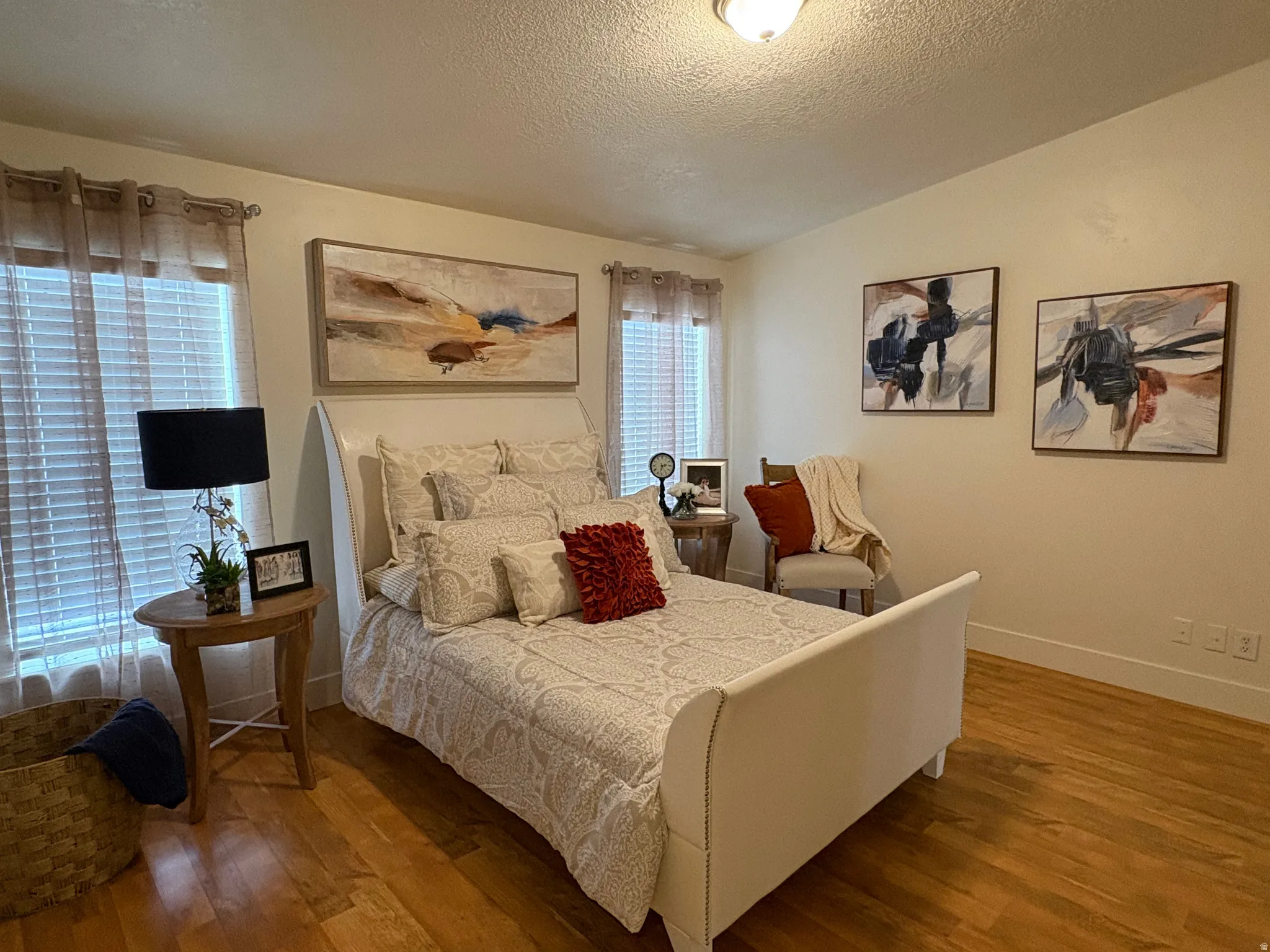 Bedroom featuring light wood-finish flooring, white baseboards, and neutral wall paint