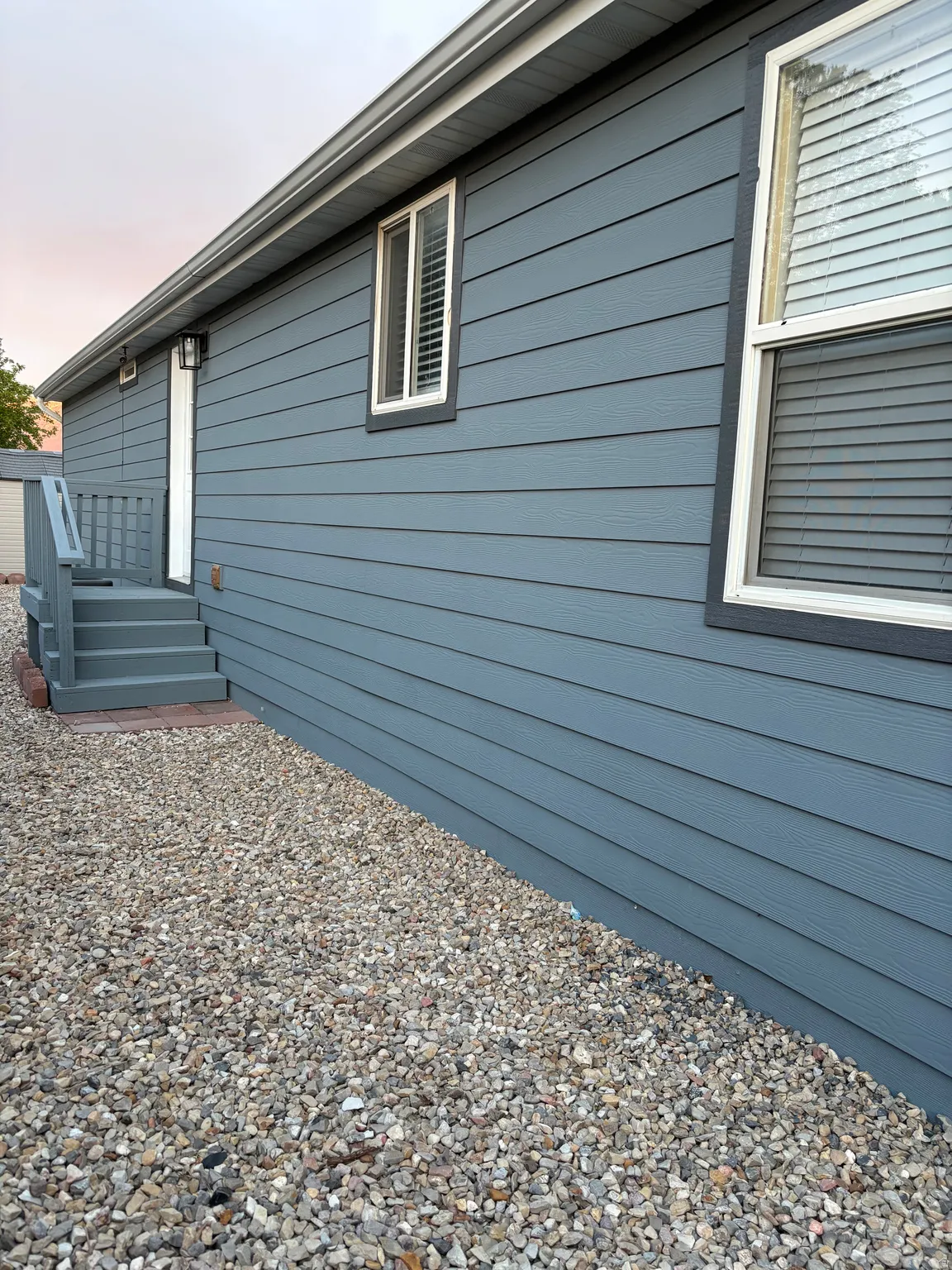 Exterior siding in a horizontal plank design, featuring multiple windows with white trim
