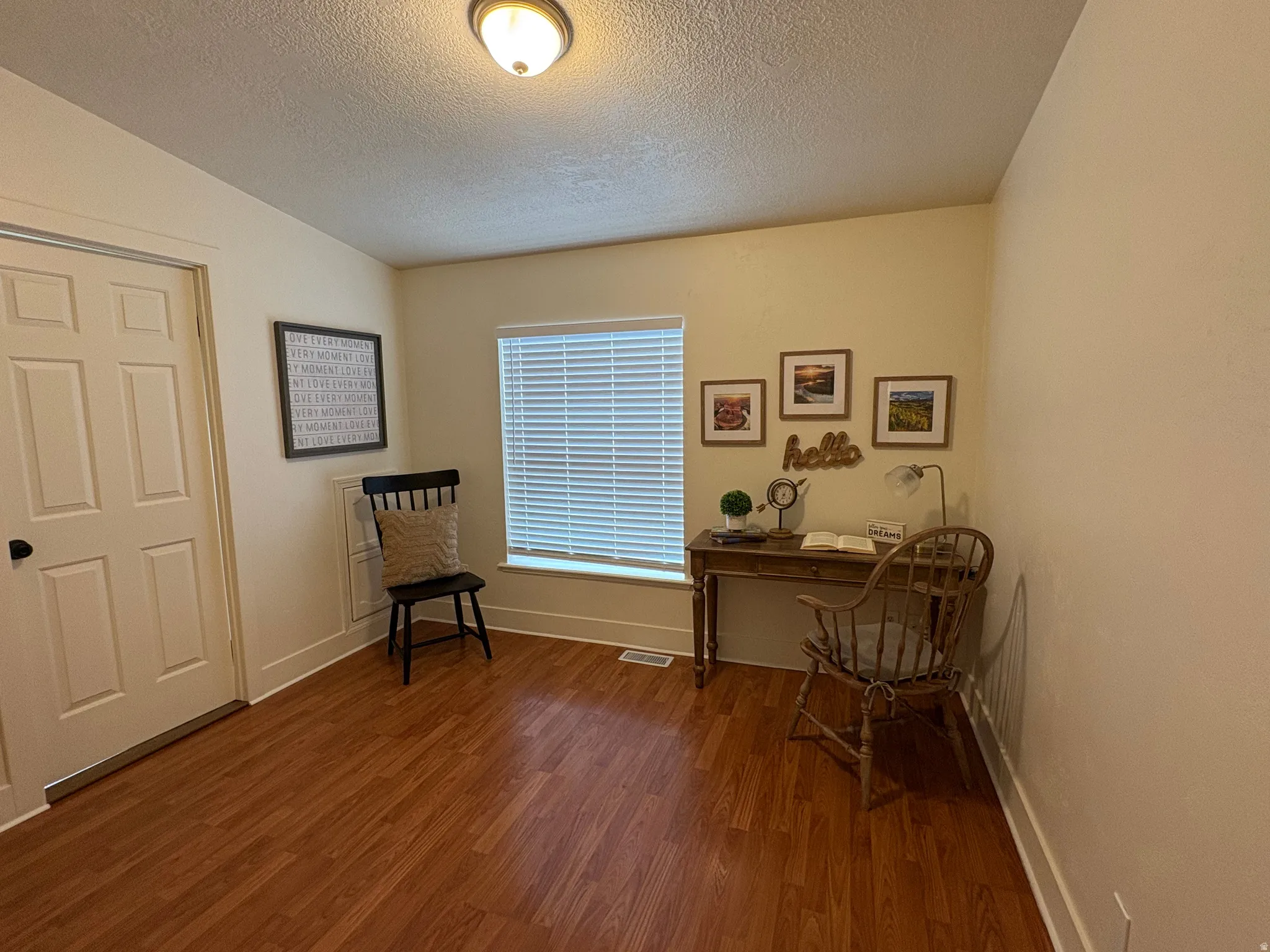 Room featuring wood-finish flooring and a white trim package