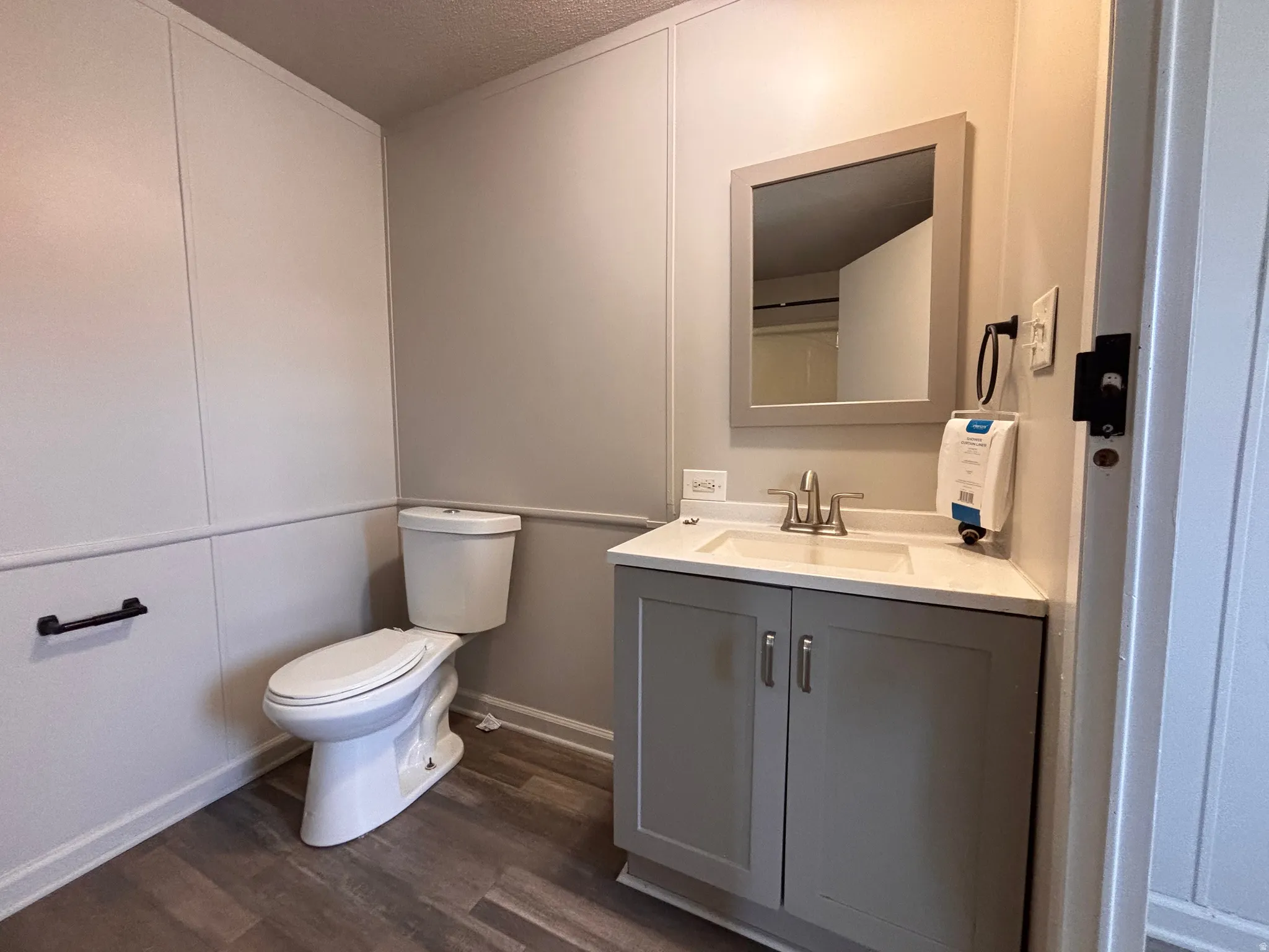 Full bathroom with a gray vanity, white countertop, and integrated sink
