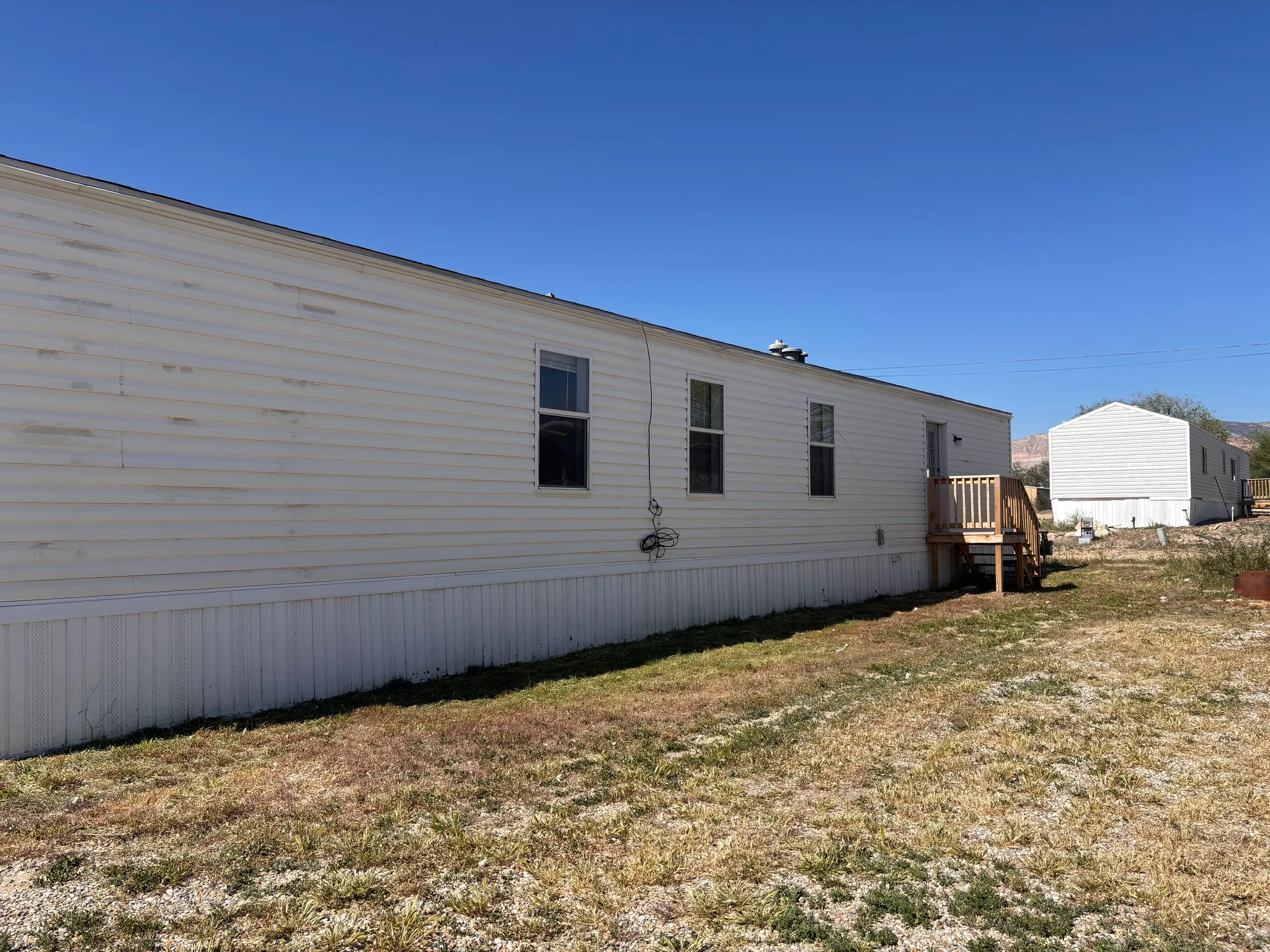 White vinyl siding exterior with multiple windows