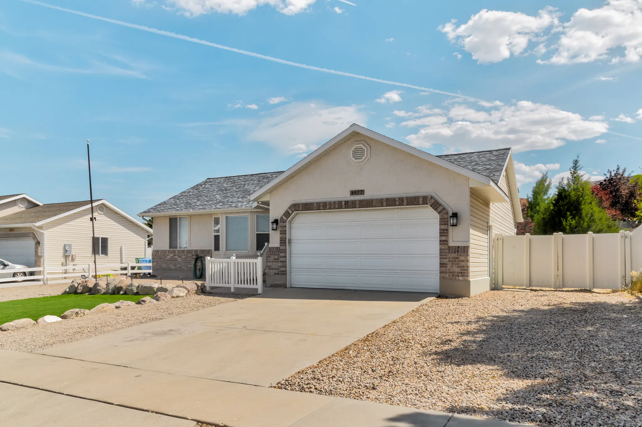 Single-story residence featuring a two-car garage with an extra tall overhead door, brick and siding exterior, More RV Parking and a shingled roof