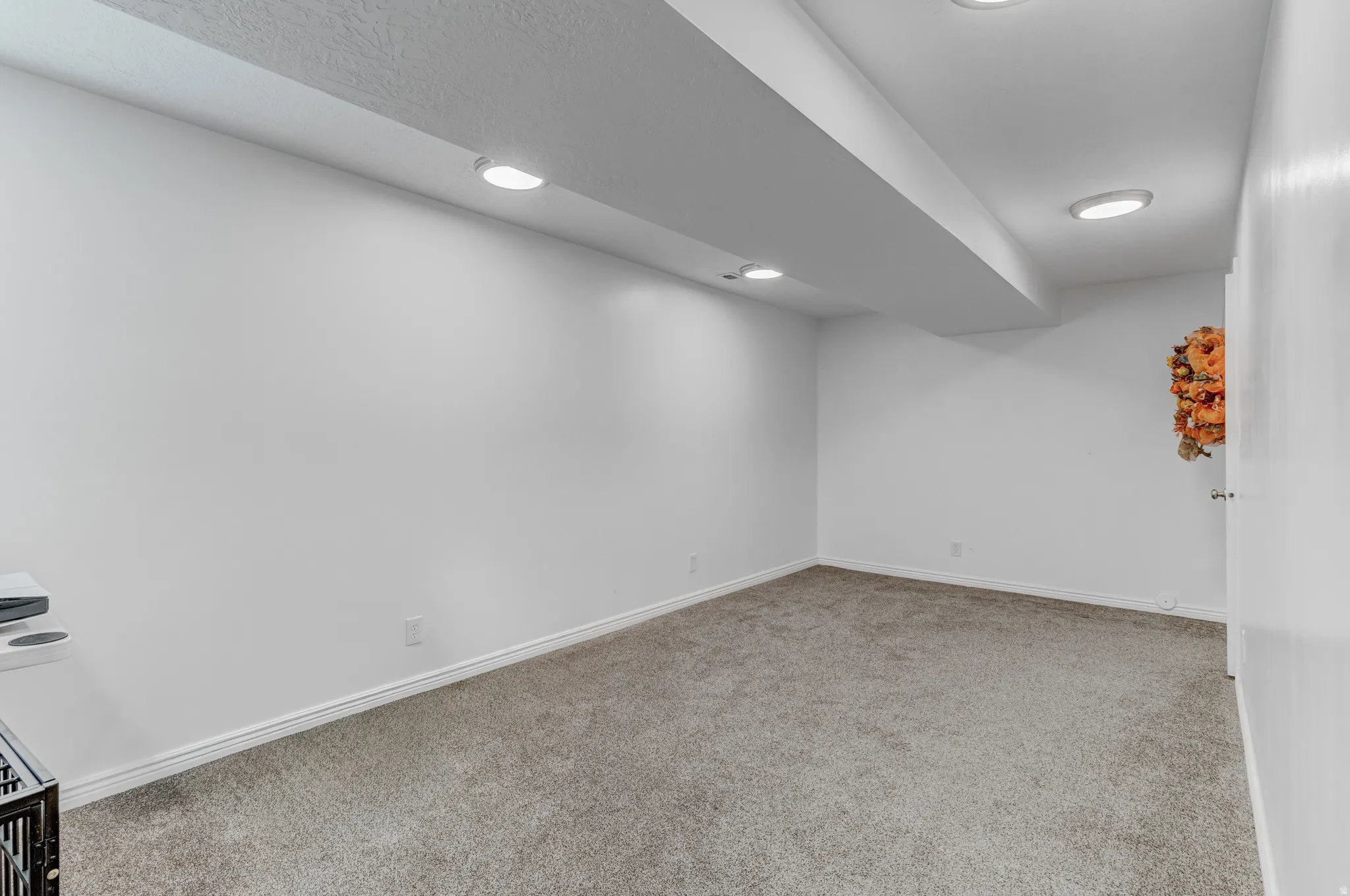 Carpeted living room featuring recessed lighting and white baseboards