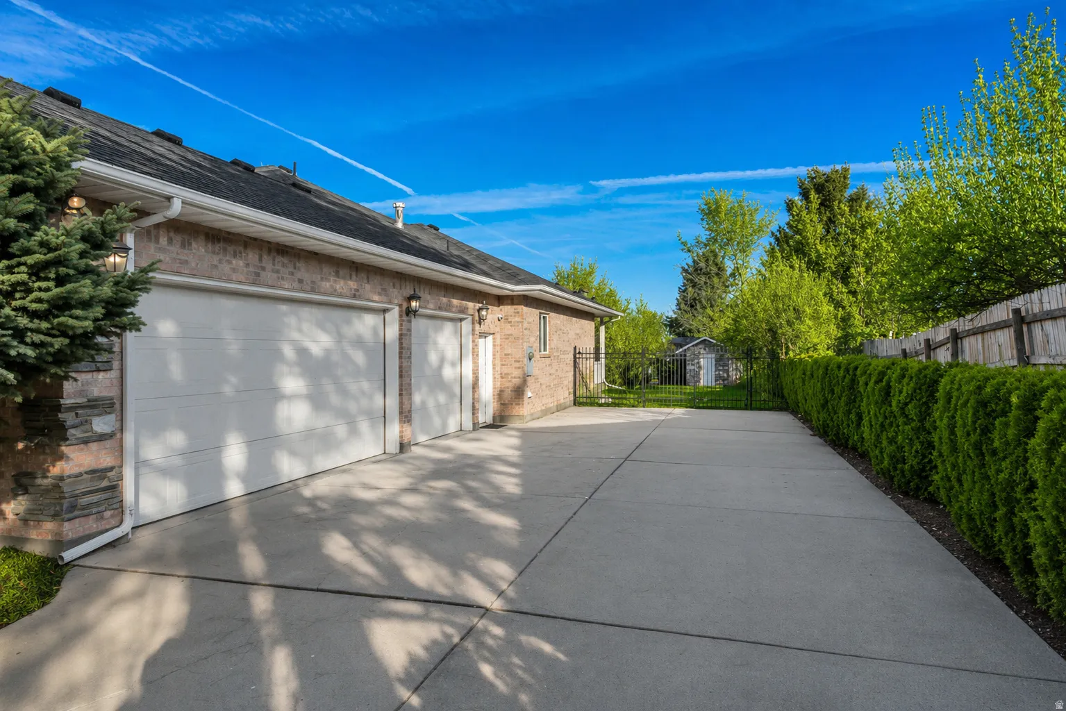 Expansive concrete driveway with a two-car garage