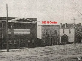 Historical Property Photograph. Displaying an urban streetscape with multiple structures and an address identifier