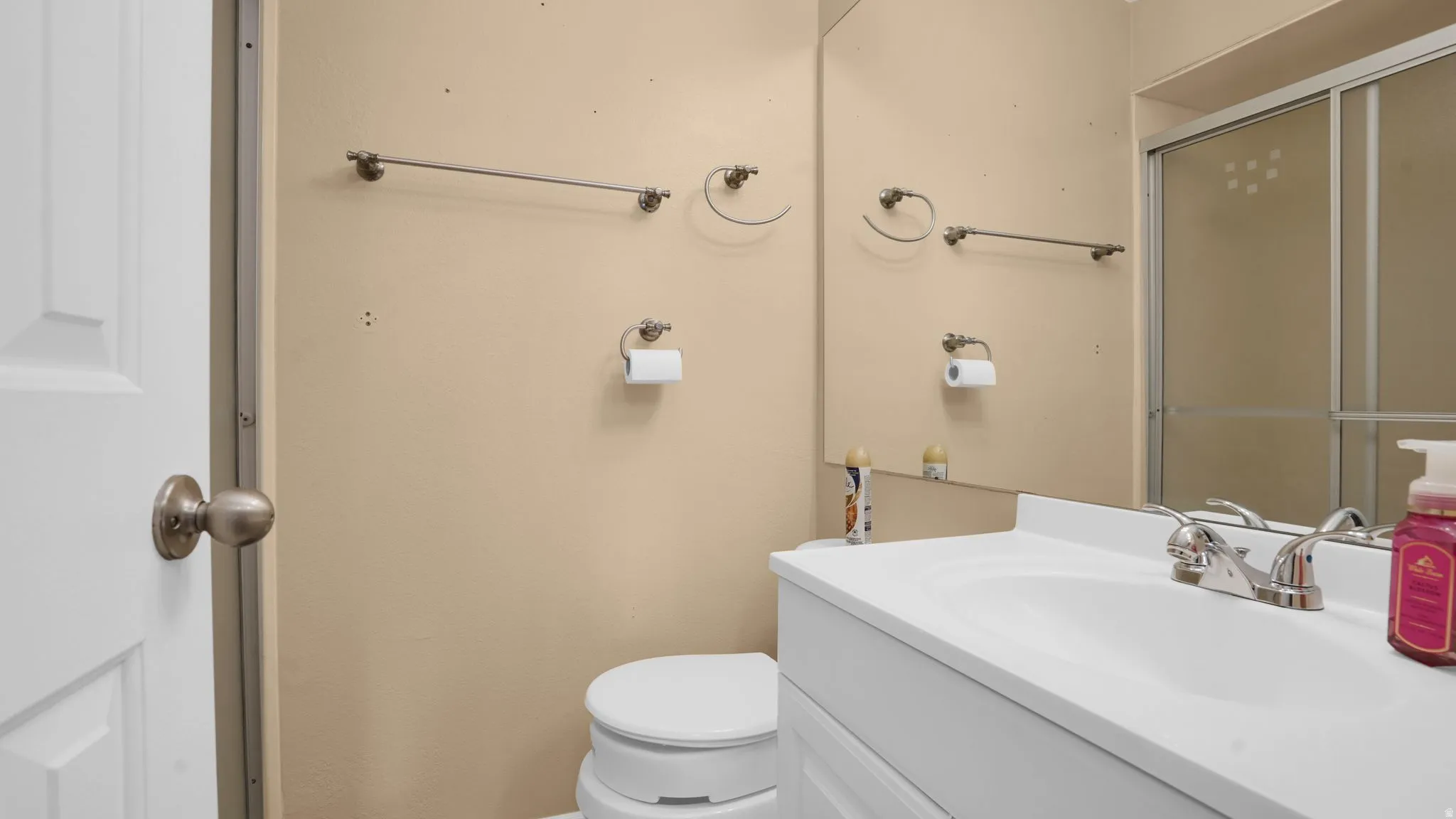 Vanity featuring a white countertop and integrated sink with a chrome faucet