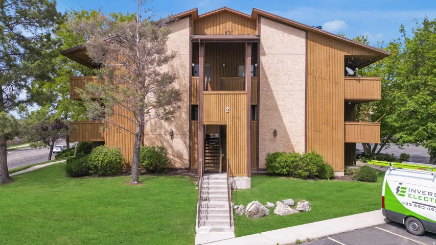 Multi-level building exterior featuring wood siding and textured facade panels