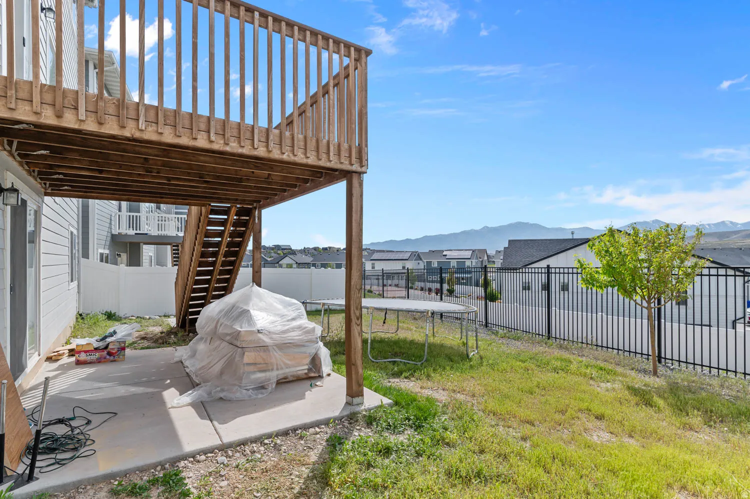 Upper-level wood deck with balustrade and stairs to grade