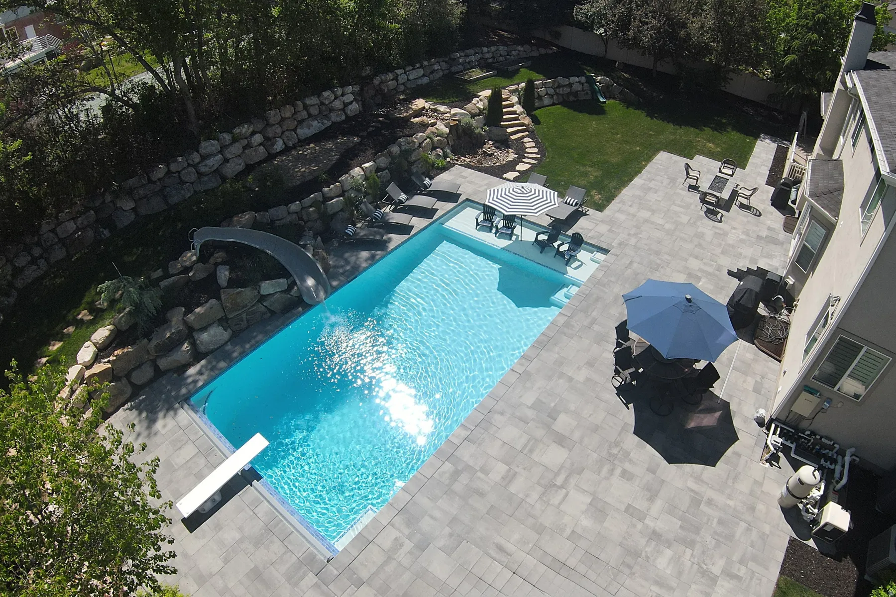 Rectangular inground pool with integrated diving board and slide