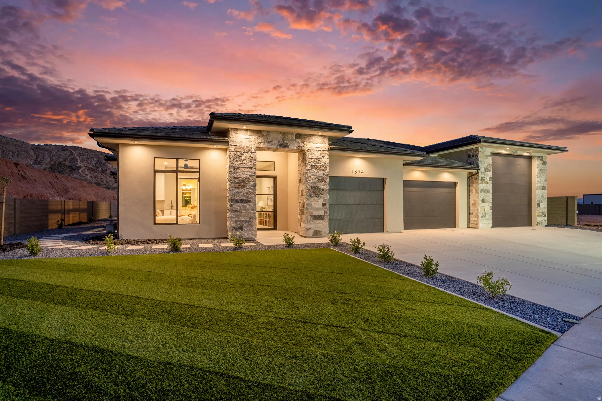 Modern architectural exterior featuring stone accents and stucco siding